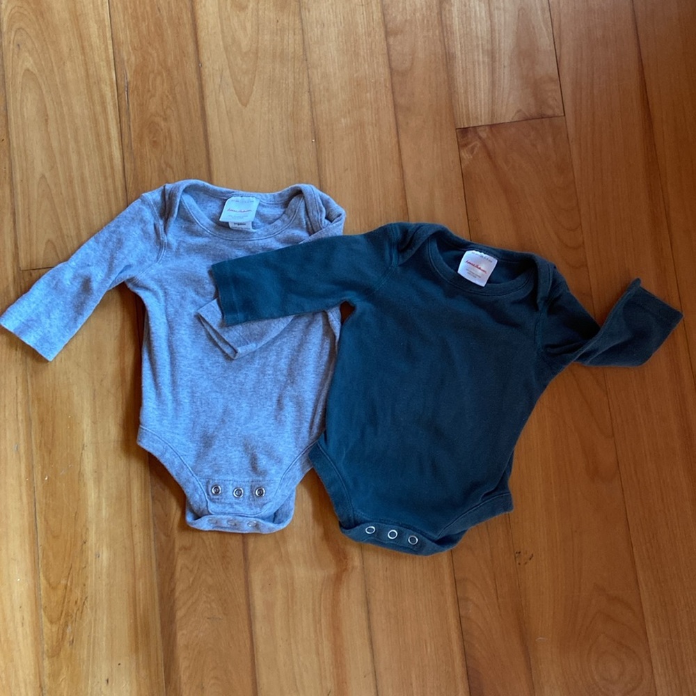 Pair of Hanna Andersson long sleeve onesies with adjustable snaps (0-3M).